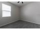 Simple bedroom with grey tile flooring and window at 4617 Harvest Row Ln, St Cloud, FL 34772