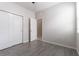 Bedroom with double door closet and grey tile flooring at 4617 Harvest Row Ln, St Cloud, FL 34772