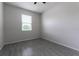 Simple bedroom with grey tile flooring and window at 4617 Harvest Row Ln, St Cloud, FL 34772