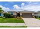 One-story home with a two-car garage and landscaped lawn at 4617 Harvest Row Ln, St Cloud, FL 34772