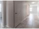 Bright hallway with light grey tiled floor and white doors at 4617 Harvest Row Ln, St Cloud, FL 34772