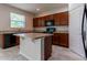 Kitchen with an island and dark wood cabinets at 4617 Harvest Row Ln, St Cloud, FL 34772
