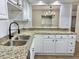 Modern kitchen featuring granite countertops, stainless steel sink, and a breakfast bar pass-through at 473 Oak Haven Dr # 473, Altamonte Springs, FL 32701