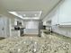 Bright kitchen with white cabinets, granite counters, and stainless steel appliances at 473 Oak Haven Dr # 473, Altamonte Springs, FL 32701