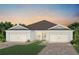 Two-story home with a two-car garage and attractive landscaping at 5180 Gardenrow Dr, St Cloud, FL 34772