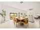 Dining area with wooden table and leather chairs near sliding doors at 6394 Chorus Dr, Mascotte, FL 34753