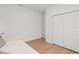 Minimalist bedroom featuring ample closet space, light wood floors, and neutral tones for a serene atmosphere at 709 Marion Oaks Mnr, Ocala, FL 34473