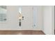 A bright white front door with sidelights is showcased with wood floors and neutral walls at 709 Marion Oaks Mnr, Ocala, FL 34473