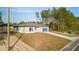 Picture of a cozy one-story house with an attached two-car garage surrounded by tall, lush trees at 709 Marion Oaks Mnr, Ocala, FL 34473