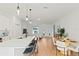Bright, open-concept living space featuring a modern kitchen, dining area, and a comfortable living room setup at 709 Marion Oaks Mnr, Ocala, FL 34473