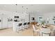 Modern kitchen with an island and bar seating, seamlessly connected to the living and dining area in an open layout at 709 Marion Oaks Mnr, Ocala, FL 34473