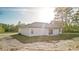 Beautiful home featuring a white exterior, neutral trim, and a backyard patio shaded with wood support beams at 709 Marion Oaks Mnr, Ocala, FL 34473