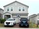 Two-story house with gray siding, two-car driveway, and basketball hoop at 7835 Syracuse Dr, Clermont, FL 34714