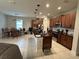 Open kitchen with island, dark wood cabinets, and breakfast nook at 7835 Syracuse Dr, Clermont, FL 34714