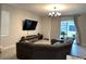Spacious living room with large sectional sofa and mounted TV at 7835 Syracuse Dr, Clermont, FL 34714