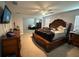 Main bedroom with large bed, ensuite bathroom, and sitting area at 7835 Syracuse Dr, Clermont, FL 34714