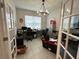 Home office with two desks, french doors, and window coverings at 7835 Syracuse Dr, Clermont, FL 34714