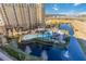 Aerial view of resort pool with pirate ship water feature, and surrounding buildings at 8101 Resort Village Dr, Orlando, FL 32821