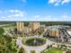 Aerial view of community with pond and buildings at 8101 Resort Village Dr, Orlando, FL 32821