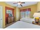 Two twin beds, dresser, and large windows with blinds at 8101 Resort Village Dr, Orlando, FL 32821