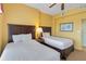 Two twin beds in a well-lit bedroom with a ceiling fan at 8101 Resort Village Dr, Orlando, FL 32821