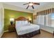 King-size bed, nightstands, and large windows with blinds in a spacious bedroom at 8101 Resort Village Dr, Orlando, FL 32821