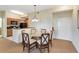 Small dining area with glass-top table and four chairs at 8101 Resort Village Dr, Orlando, FL 32821
