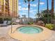 Relaxing hot tub with lounge chairs and palm trees nearby at 8101 Resort Village Dr, Orlando, FL 32821