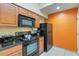 Updated kitchen featuring black appliances and granite counters at 8101 Resort Village Dr, Orlando, FL 32821