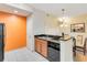 Well-equipped kitchen with modern appliances and orange accent wall at 8101 Resort Village Dr, Orlando, FL 32821