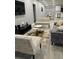 Spacious living room with gray sofa, patterned bench, and modern coffee tables at 943 Derbyshire Dr, Kissimmee, FL 34758