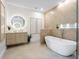 Modern bathroom featuring stylish fixtures, a spacious tub, and natural accents enhance this spa-like retreat at 9697 Bryanston Dr, Orlando, FL 32827