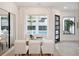 Bright dining area with views of the pool through large windows and modern decor at 9697 Bryanston Dr, Orlando, FL 32827