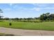 Scenic view of the lush green golf course with blue skies and pond views at 9697 Bryanston Dr, Orlando, FL 32827