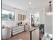 Bright hallway with a built in desk, modern lighting, and neutral walls provide a calm space to relax and work at 9697 Bryanston Dr, Orlando, FL 32827