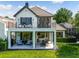 Two-story home showcasing a large backyard patio and balcony at 9697 Bryanston Dr, Orlando, FL 32827