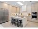 Bright modern kitchen with a large island, sleek cabinetry, and stainless steel appliances at 9697 Bryanston Dr, Orlando, FL 32827