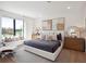 Spacious bedroom with a plush king bed, modern decor and natural light offer a serene view at 9697 Bryanston Dr, Orlando, FL 32827