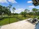 Relax on this patio with comfortable lounge seating and a view of a picturesque golf course under a clear sky at 9697 Bryanston Dr, Orlando, FL 32827