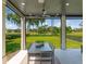 Covered patio with outdoor seating and golf course view at 9697 Bryanston Dr, Orlando, FL 32827