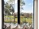 A stunning golf course and water view from a window with modern cushions and pillows at 9697 Bryanston Dr, Orlando, FL 32827