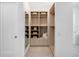 Spacious walk-in closet with built-in shelves and drawers at 9697 Bryanston Dr, Orlando, FL 32827