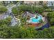 Aerial view showing a community pool, spa, and clubhouse at 5356 Diplomat Ct # 107, Kissimmee, FL 34746