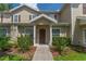 Inviting exterior of a two-story townhome with a walkway and landscaping at 5356 Diplomat Ct # 107, Kissimmee, FL 34746