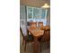 Dining room features a wood table with chairs and access to a screened patio at 1013 Park Ridge Cir, Kissimmee, FL 34746