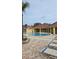 Community pool with lounge chairs and patio area at 1013 Park Ridge Cir, Kissimmee, FL 34746