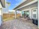 Private backyard patio with seating area and wood privacy fence at 10175 Peebles St, Orlando, FL 32827