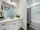 Modern bathroom with white vanity and subway tile shower at 10175 Peebles St, Orlando, FL 32827