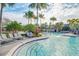 Community pool with lounge chairs and palm trees at 10175 Peebles St, Orlando, FL 32827