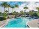 Curved community pool with lounge chairs and a covered patio at 10175 Peebles St, Orlando, FL 32827